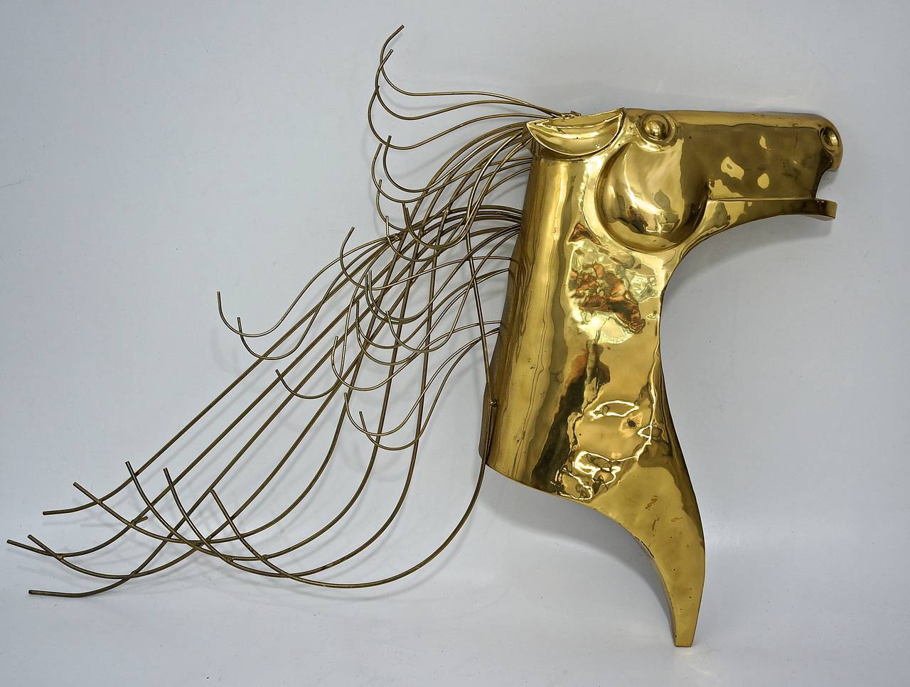 This monumental scaled iconic C. Jere Mustang wall sculpture was created in 1984 by Artisan House Inc. of Los Angeles, Ca..

This stylized Mustang head with flowing and undulating mane was designed  C. Jere in 1984 and was fabricated by Artisan