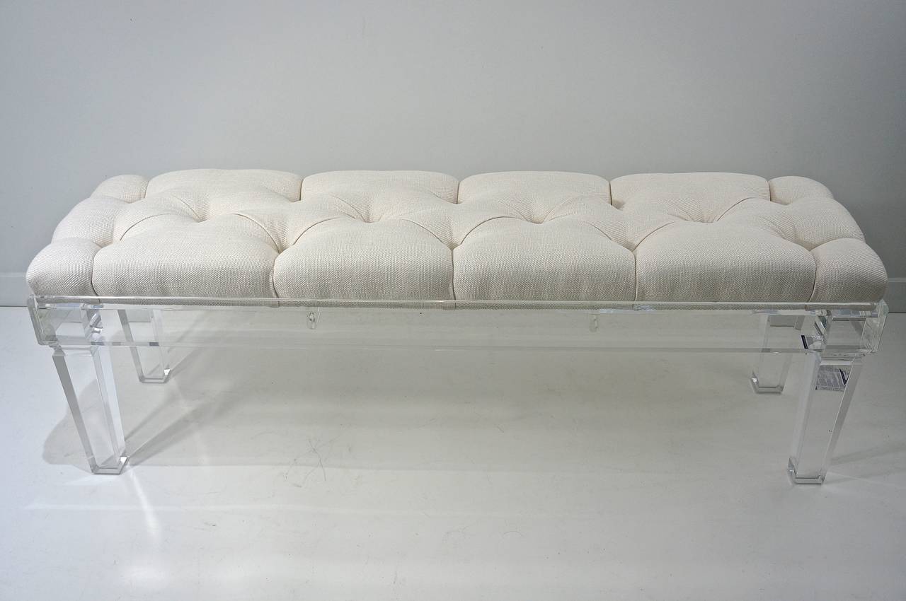 This beautiful acrylic bench was custom designed in the Louis XVI style with tapered legs. The button-tufted upholstery is a woven cotton-blend fabric in a cream-white color. 

Please feel free to contact us directly for a shipping quote, or other