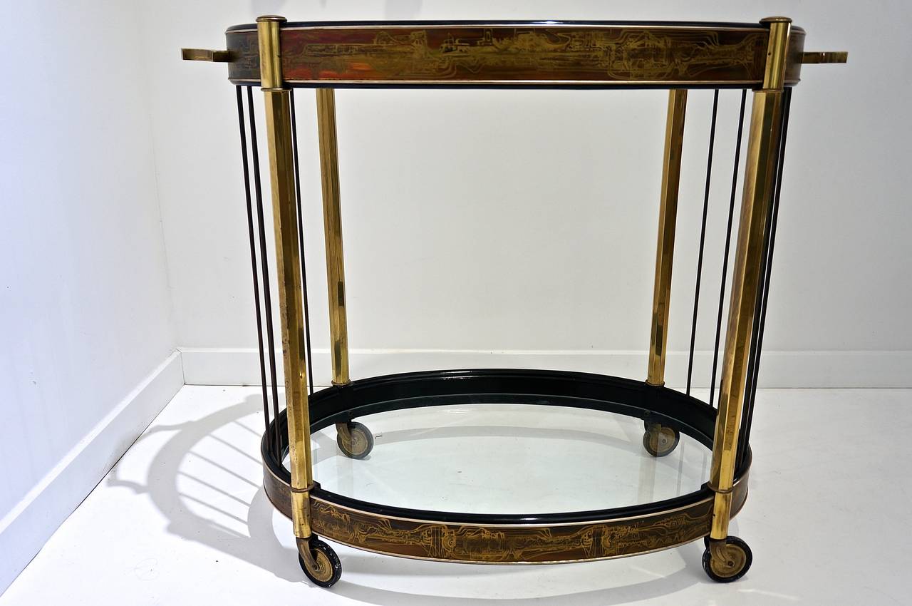 This beautiful two-tiered bar cart/trolley was produced in the 1970's by Mastercraft Furniture.  Mastercraft Furniture was know for producing chic modern American glamorous and elegant furniture. 

This piece was designed by the Iconic sculptor