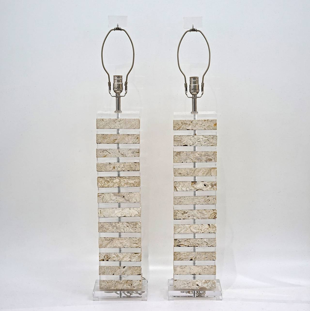 This pair of Karl Springer-style table lamps are monumental in their scale and beauty.  Each lamp, with polished chrome stems and 3-way sockets, has been rewired and is comprised of 12-pieces of fossilized Coquina stone/coral in a soft, chalky,