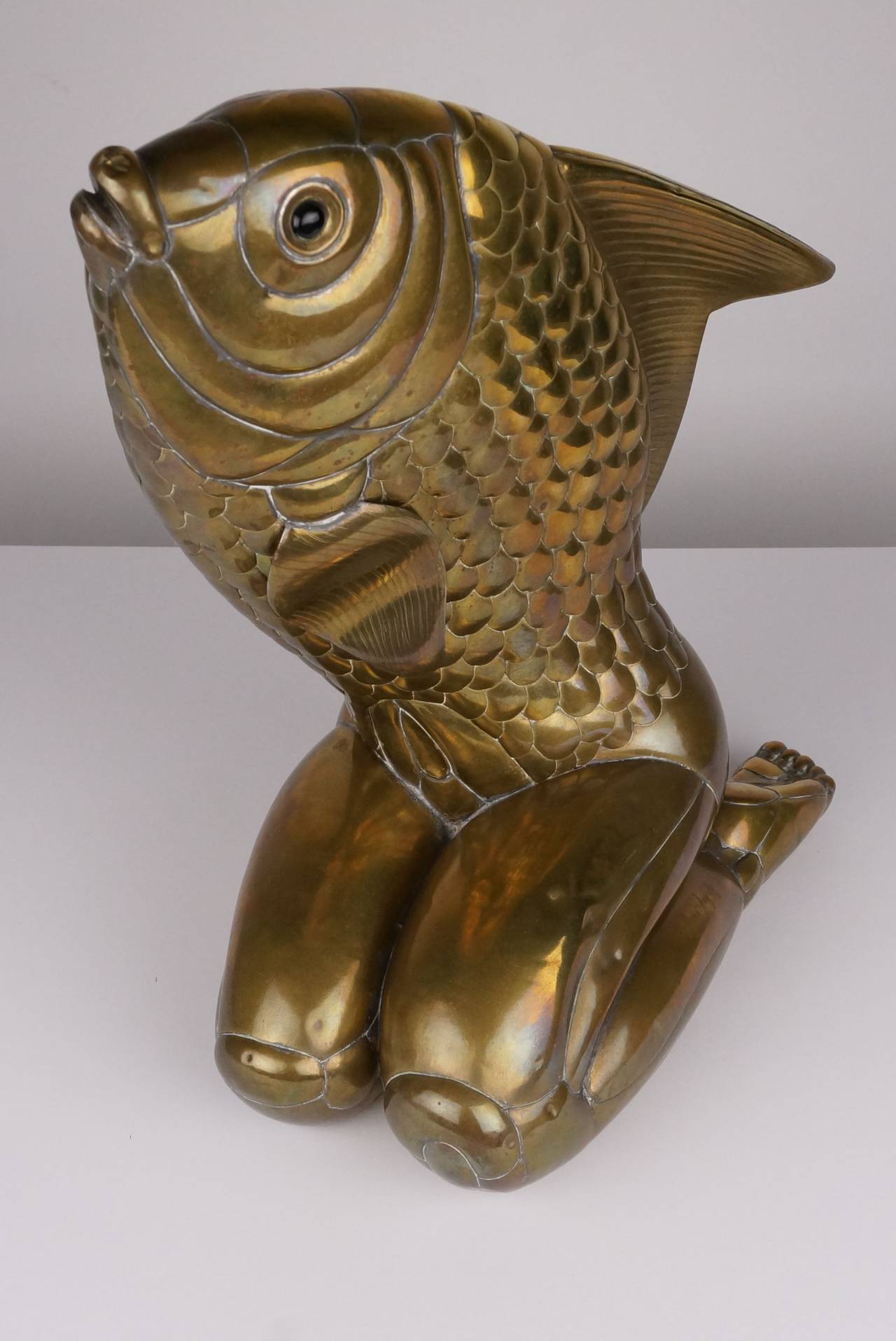 This Surrealist sculpture created in brass is depicting a female form with the head of a fish and was created in the 1970s by the artist Mano Gonzalez. It is signed Mano Gonzalez 6/100.

Gonzalez might have taken inspiration from the painting
