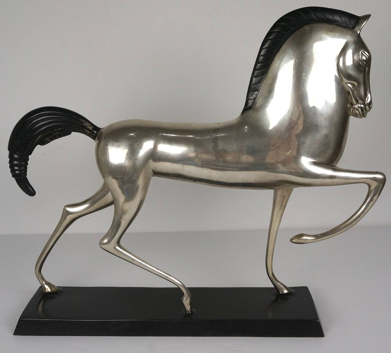 This incredible Mid-Century, Art Deco style Etruscan bronze horse is in the style of Boris Lovet-Lorski.  The body of the horse is silver-plated and the mane and tail are painted black, as is the base.

Boris Lovit-Lorsky (1894-1973) 

The