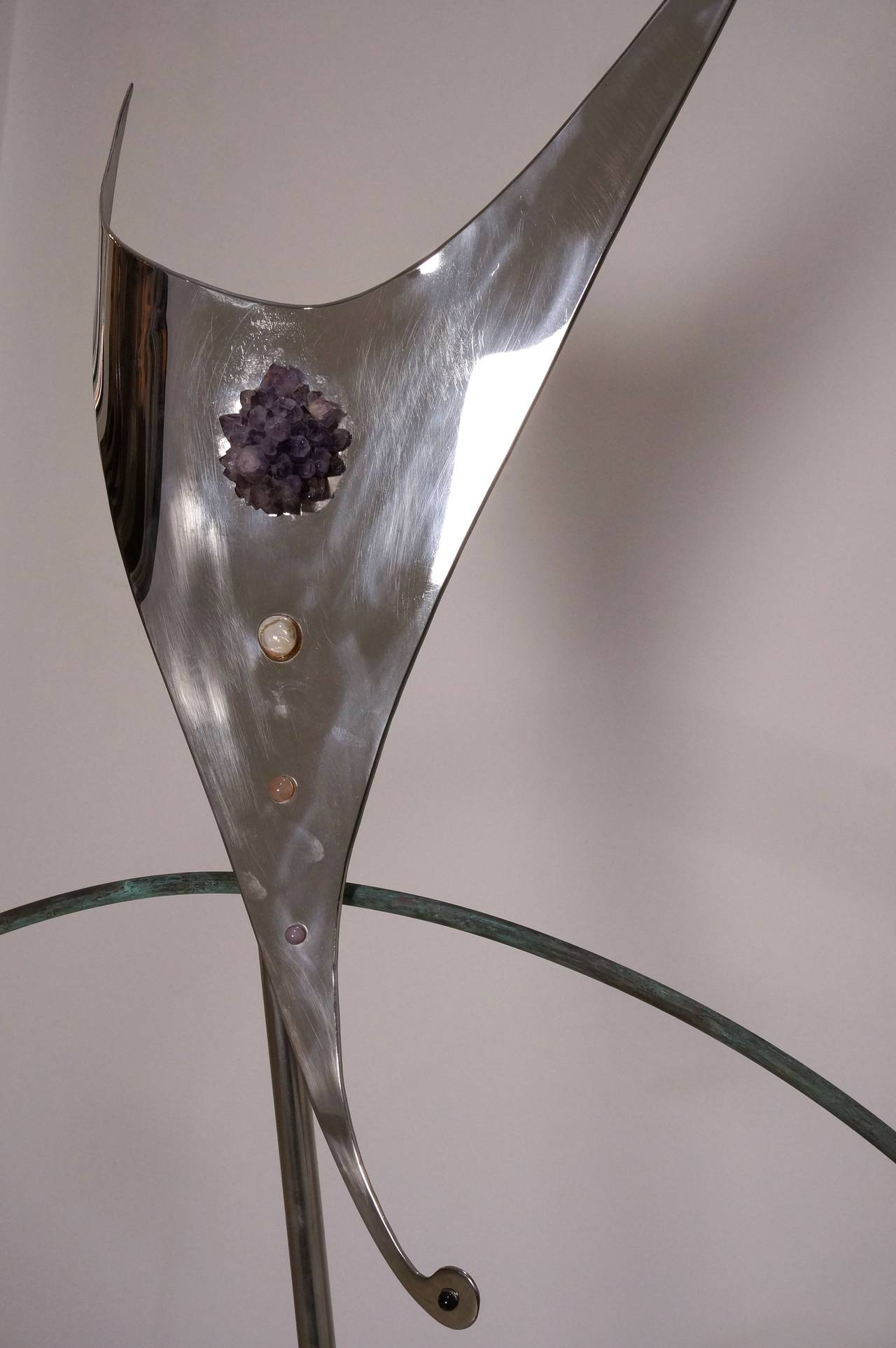 This amazing illuminated sculpture is made of stainless steel, copper, amethyst, rose quartz and molded glass. The free-form has a graceful presence and elegance. 

Note: The piece requires one Edison based bulb.

