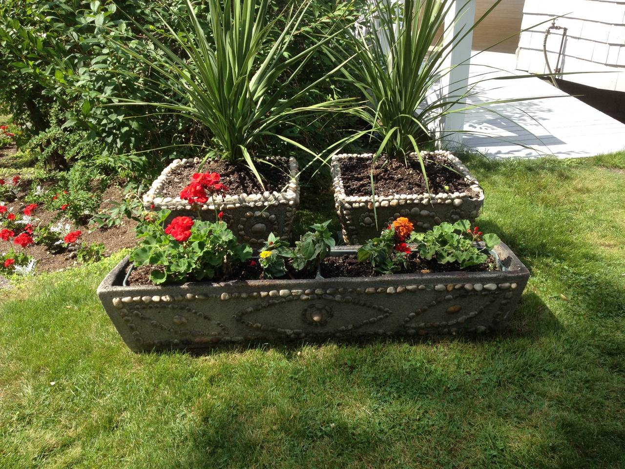 Here's a beautiful old American antique set of three (3)  hand made and hand inlaid circa 1915 stone planters- unique.

Background:  These unique antique planters were crafted in a refined hand made style with iron armature, concrete, and inlaid