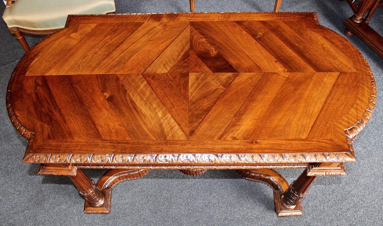 This French table is made from a superb yew wood.  The table features ornate, hand-carved details and a parquet top.  This piece is the perfect size to be used as an occasional table or side table.