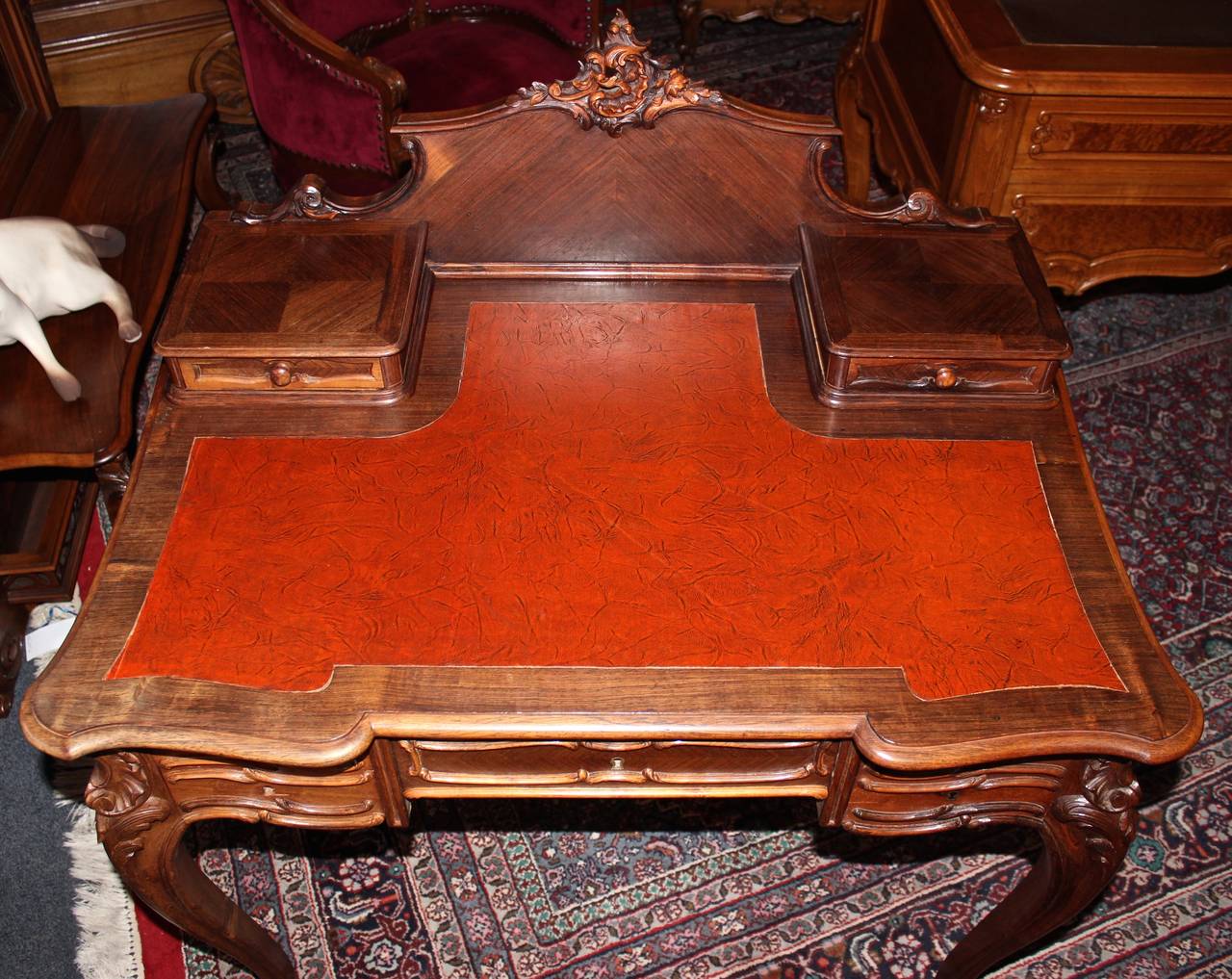 This French ladies vanity or desk was made in the Louis XV style by Mercier Freres.  It features a gorgeous, red leather top.  Storage includes multiple pull-out drawers, one of which includes a divided insert.