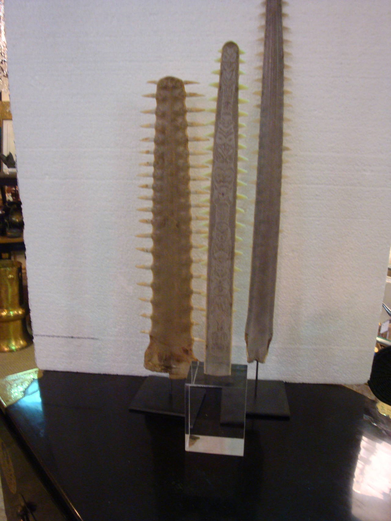This is a collection of three sawtooth bills on various stands, one with ethnographic etching inscribed on bill.