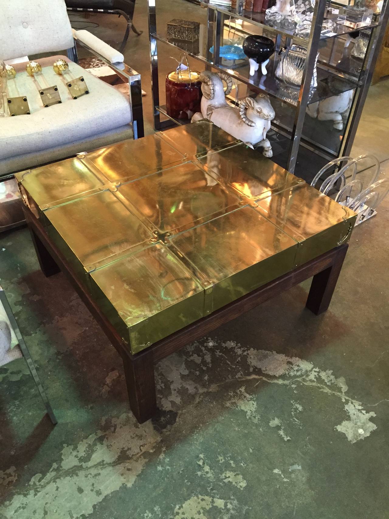 Brass coffee/cocktail table by Sarreid having brass hinged decoration all raised on the original walnut base.