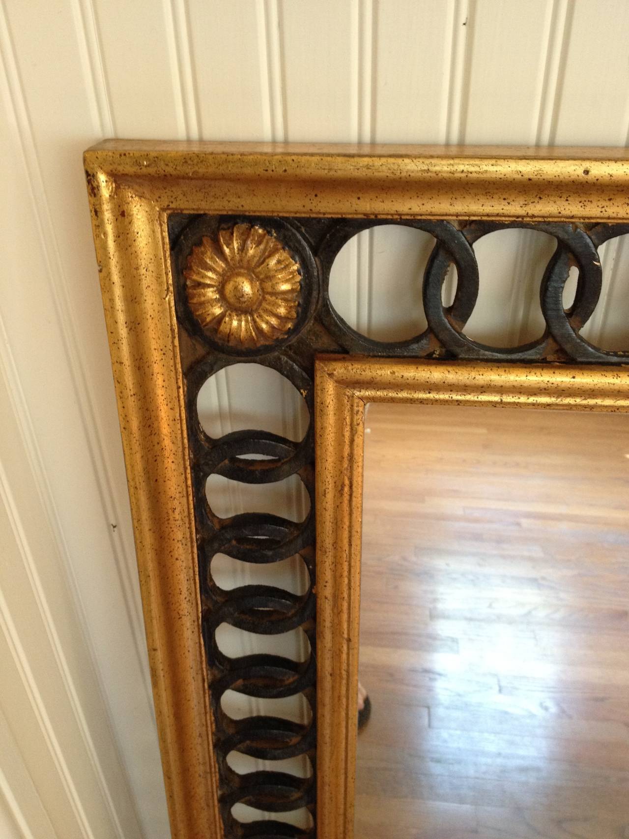 A gilt wood mirror with interlocking black circles by LaBarge
