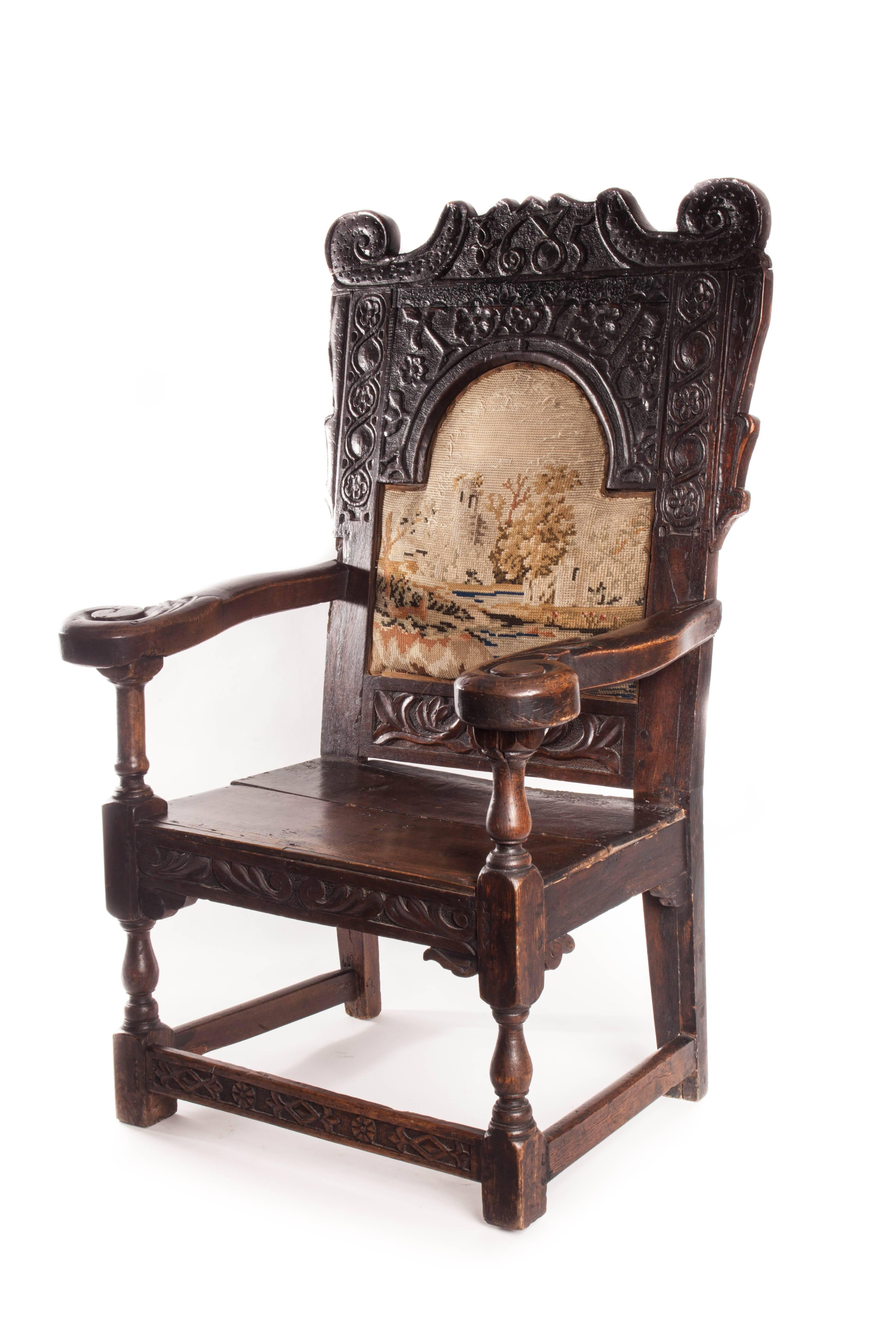 Beautiful 17th century English Jacobean armchair. Carved floral motifs and inset tapestry back. Date is carved into the back head rest. 1685.
