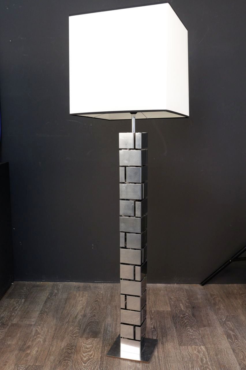 1970s floor lamp in folded metal. Building model by Curtis Jere. Folded stainless steel trunk and square base. Square cotton lampshade redone according to the original. This floor lamp is in good condition consistent with age and use. Minor wear on