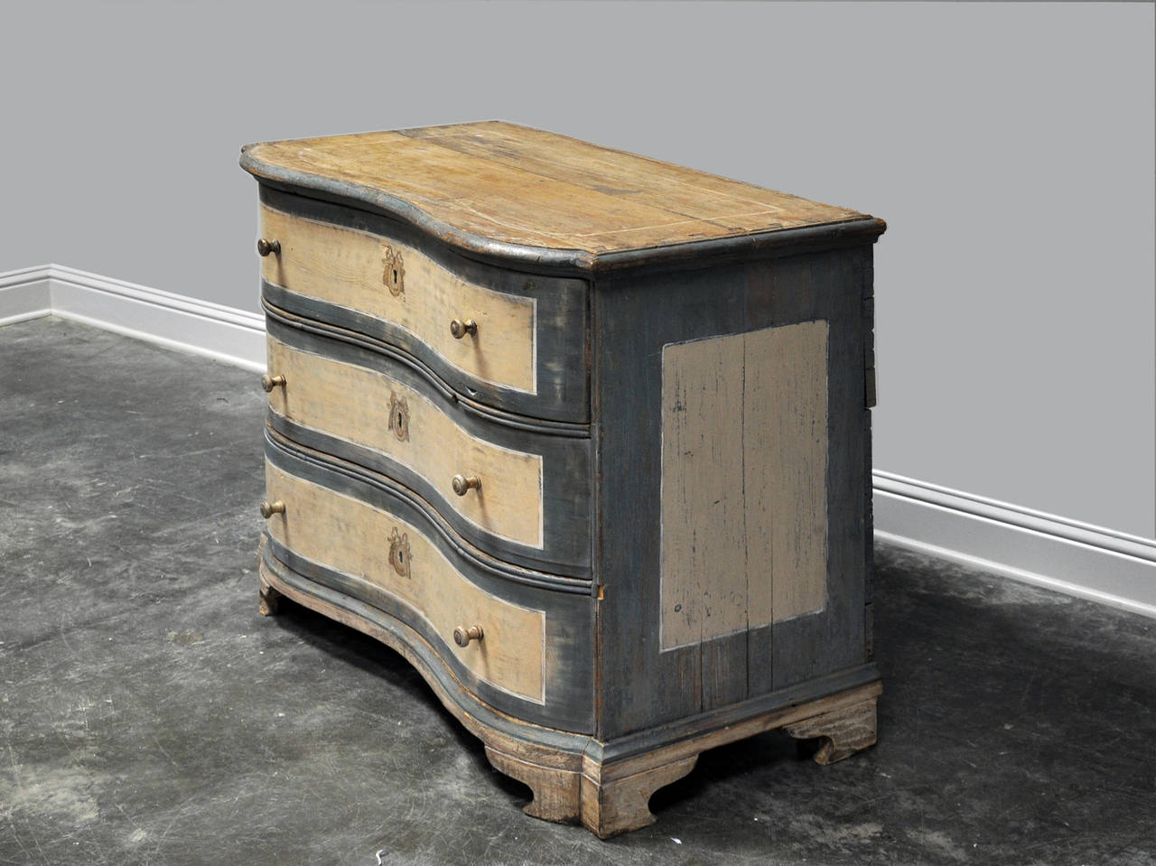 Bow front painted commode, 18th century of probable Austrian or German origin with bracket feet. Painted and patinated, charming touch with painted key escutcheons. 

Established in 1979, Joyce Horn Antiques, ltd. continues its 36 year tradition