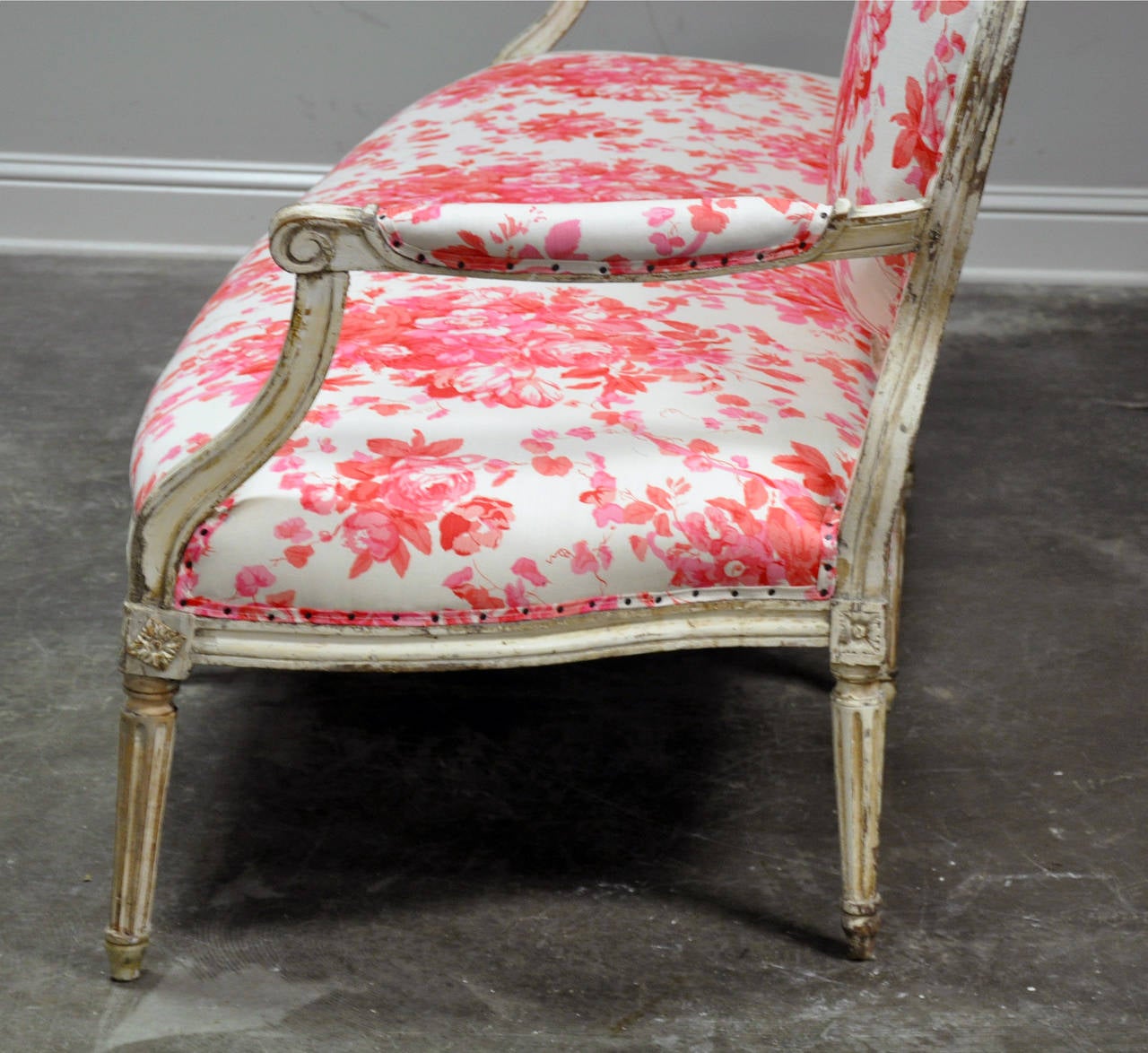 French Painted, early 19th c. Louis XVI style settee upholstered in Bennison fabric.