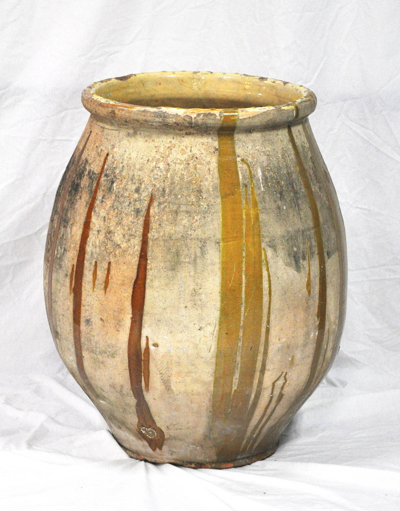 Handmade, much in demand antique French 'Biot' Olive Oil Pot; Biot, France. 19th century. Clay body particular to that region. 

Established in 1979, Joyce Horn Antiques, ltd. continues its 36 year tradition of being a family owned and operated
