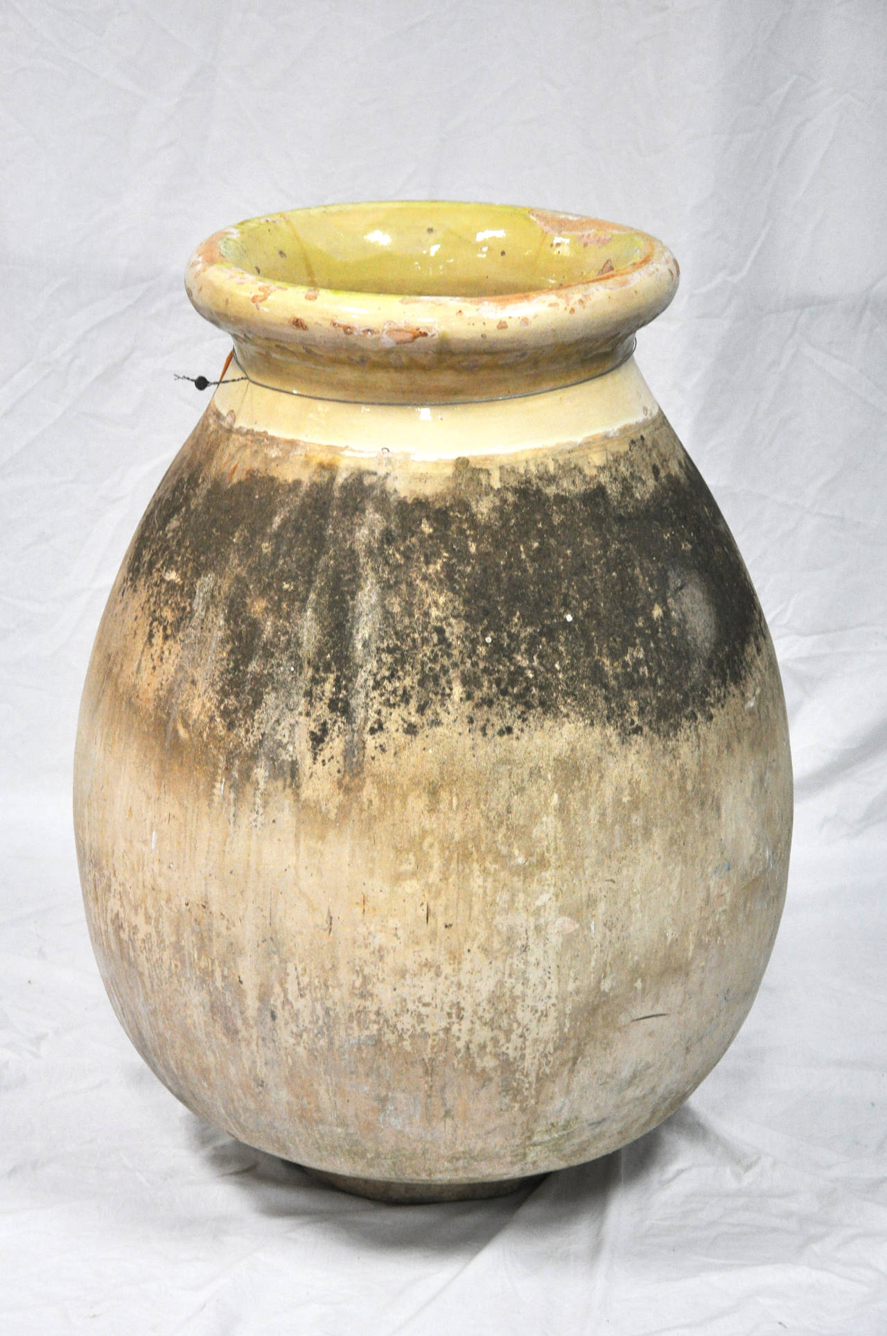 Handmade, much in demand antique French 'Biot' Olive Oil Pot; Biot, France. 18th century. Clay body particular to that region. 

Established in 1979, Joyce Horn Antiques, ltd. continues its 36 year tradition of being a family owned and operated