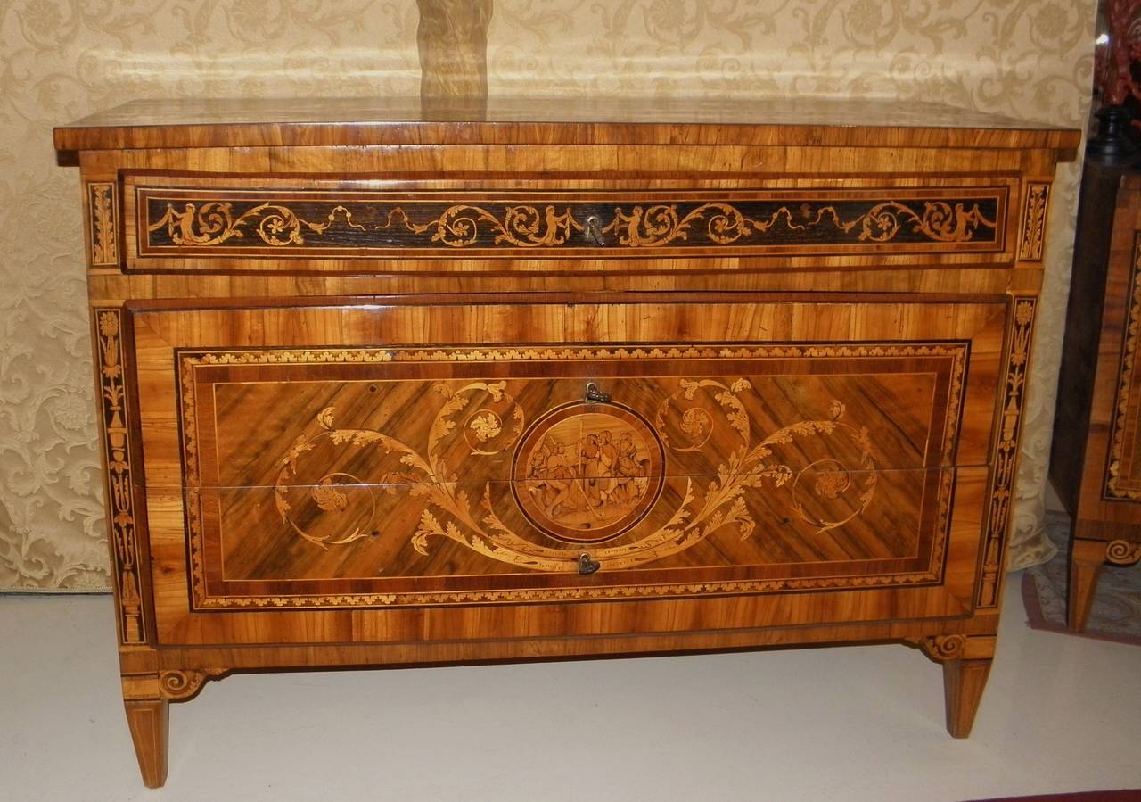 A marquetry inlaid commode with three drawers, two big and one smaller, foliage and a medallion on the front and sides, with 
acanthus leaves on top of the commode and on top of side cabinet, the front medallion of the side cabinet is the same of