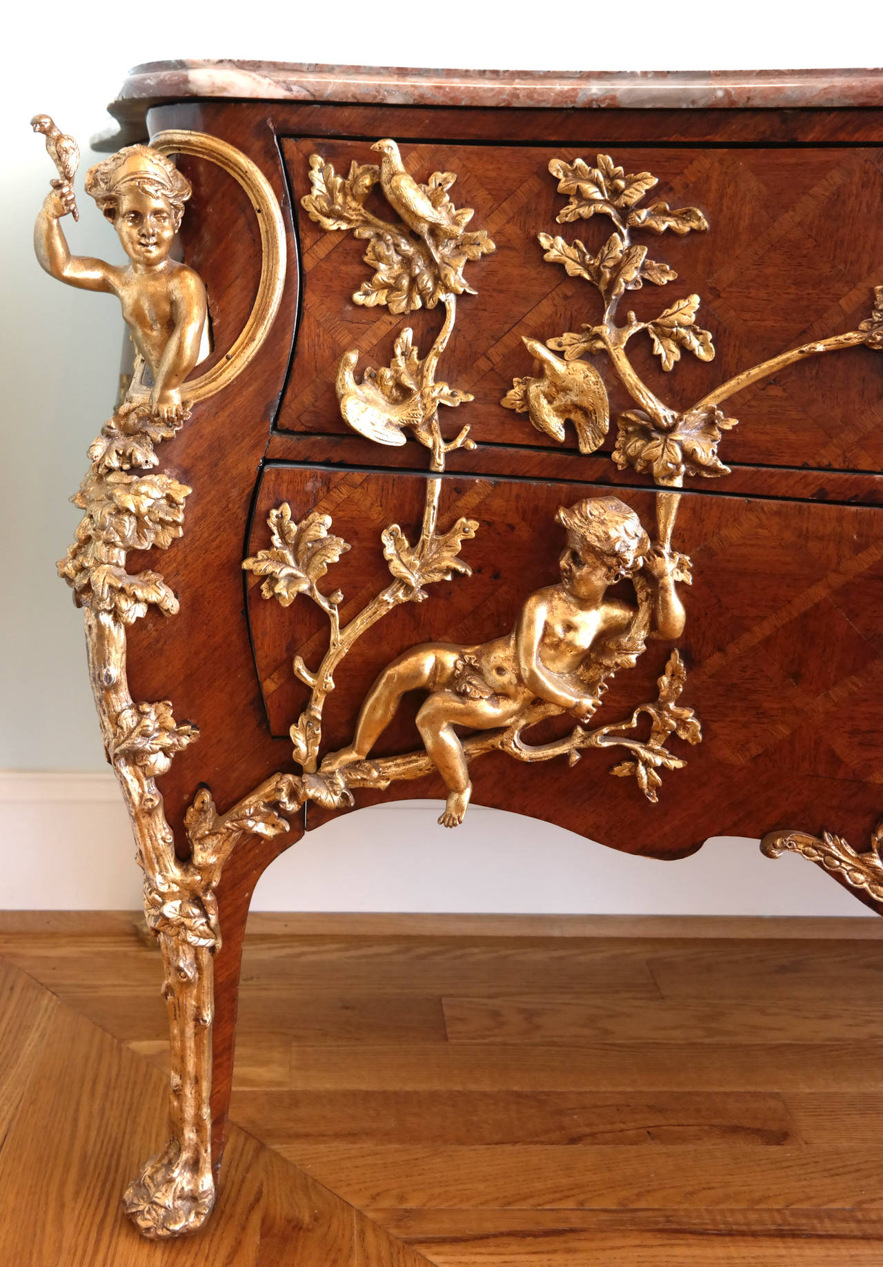 A Regence style gilt bronze mounted kingwood and trellised parquetry commode in the manner of Charles Cresscent, France, ca. 1900