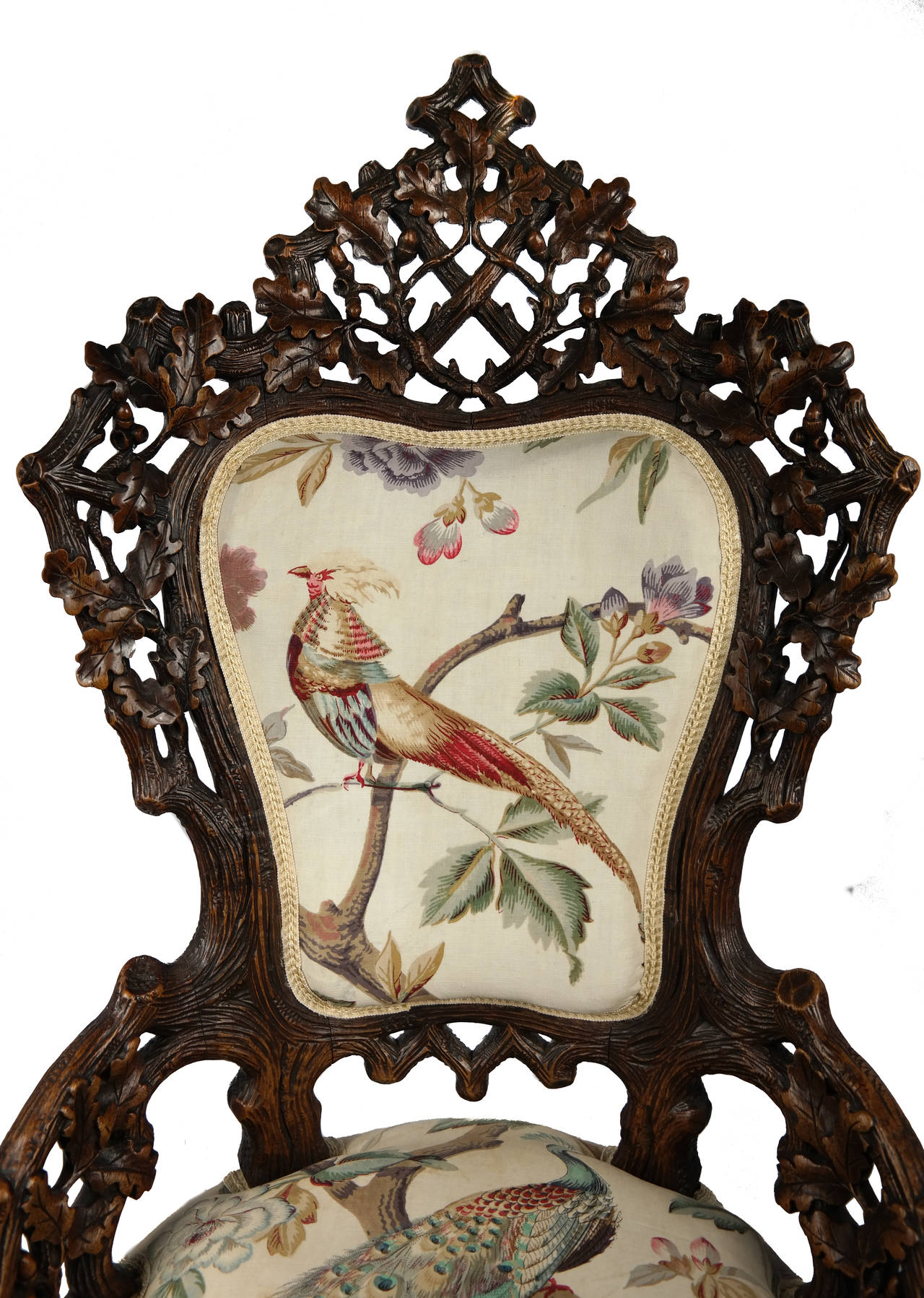 Late 19th Century Black Forest Carved Oak Chair, Swiss circa 1880. Re-upholstered in beautiful hand block printed fabric decorated with pheasants and peacocks. 