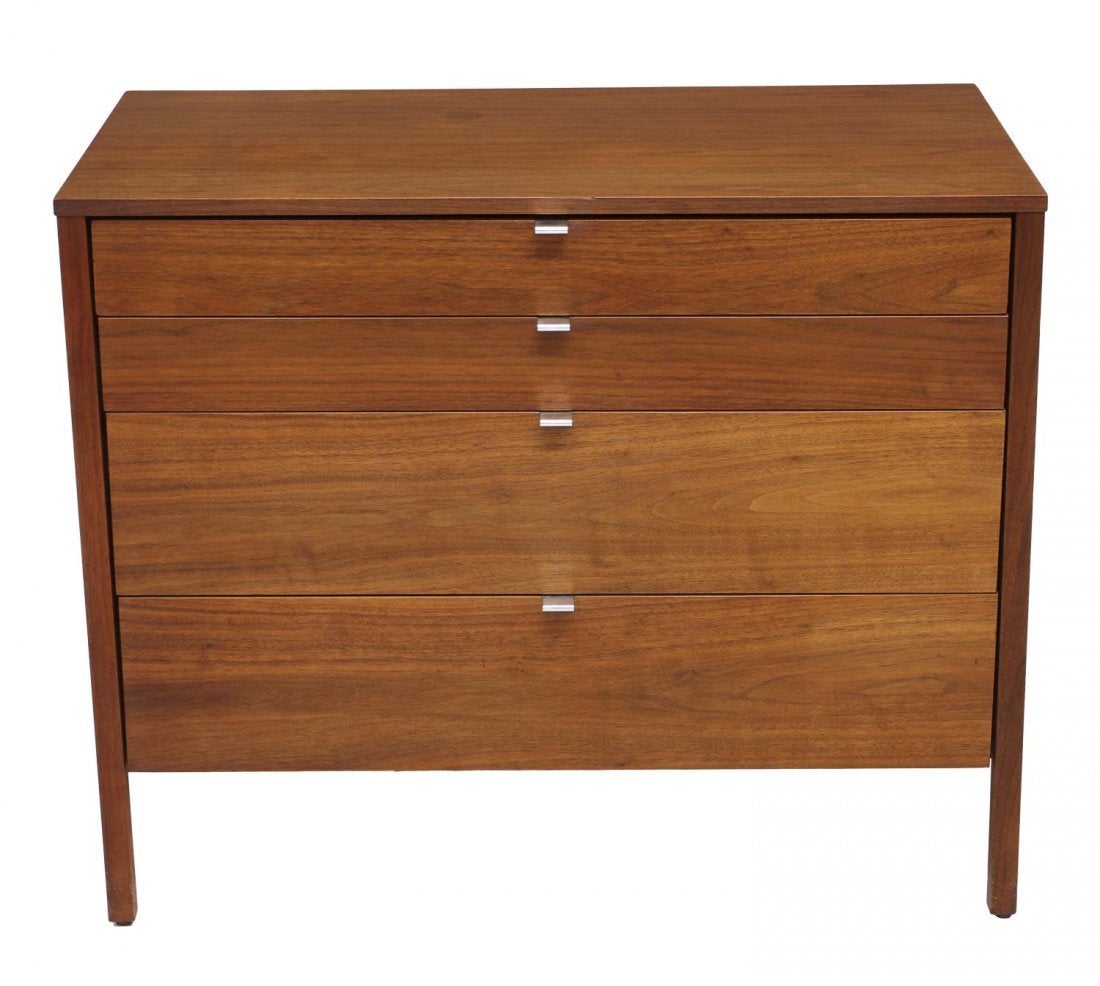 Pair of Knoll Teakwood dressers, designed by Florence Knoll, rectangular with four graduated drawers with aluminum pulls, rising on straight squared legs. Each has Knoll tag in drawer interior.