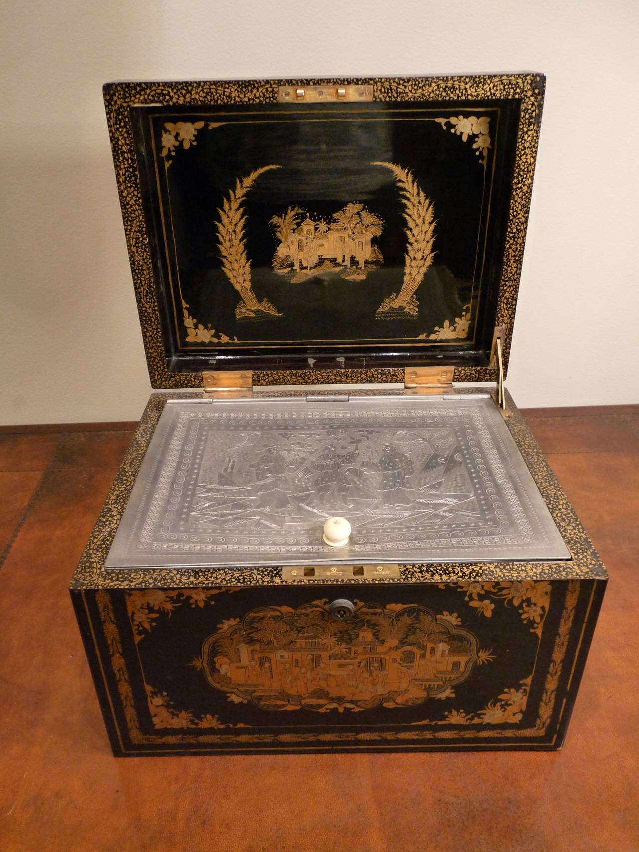An impressive black and gold Chinese Export tea chest with an engraved metal interior liner. Fittings are brass and bone. Included are items showing the provenance of the chest: three photographs of Mr. Adair Struthers, who was a tea merchant in