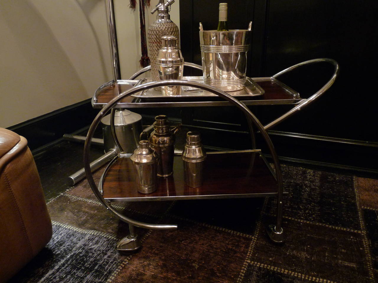 A stylish and functional rosewood veneer and chrome drinks trolley.