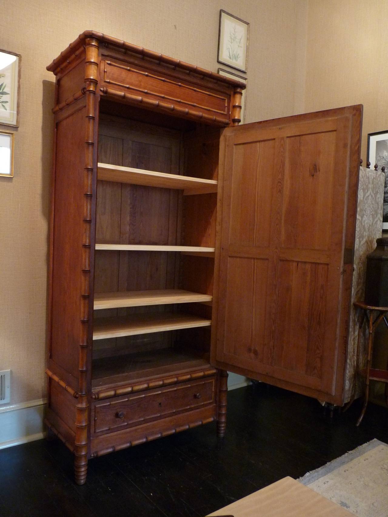 A lovely English faux bamboo wardrobe, beautifully constructed with a full length mirror and bottom drawer. Interior has four newer fitted shelves, which are adjustable.