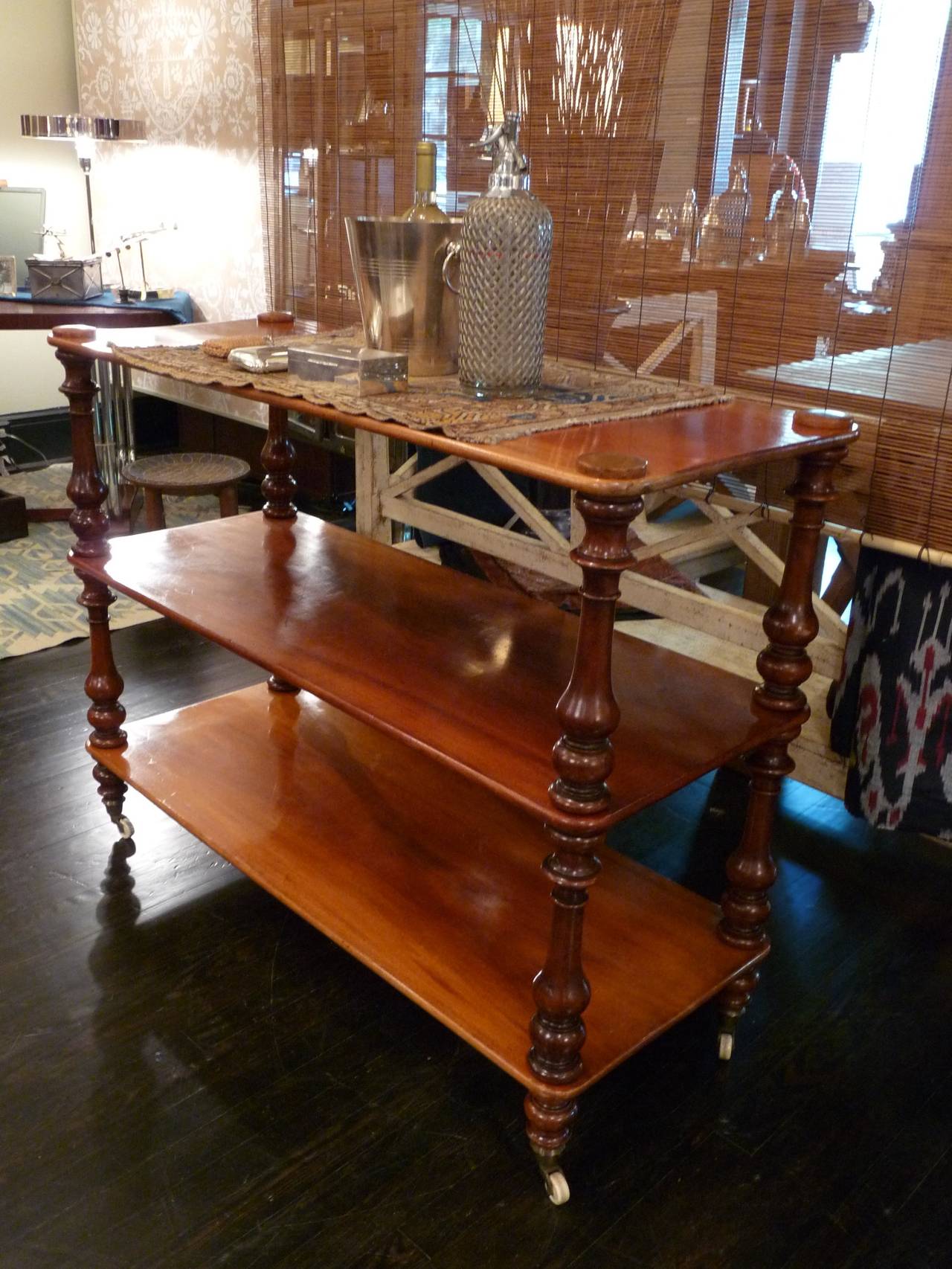 This rare, British Campaign buffet stands with bold, turned columns and a plain, rounded edge to the shelves.  The columns to the server are fitted with wooded screws and threads so that it will dismantle with ease.  Campaign buffets are considered