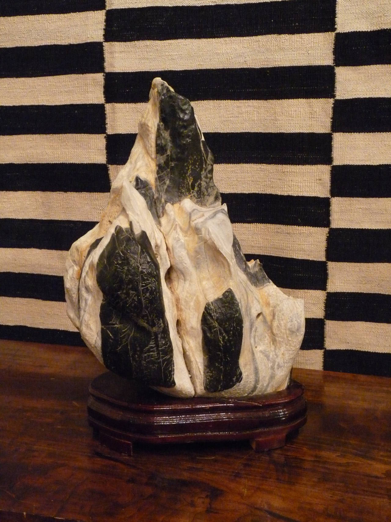 Scholar's rocks (or Gonshi) began as stones that resembled or represented mythological or famous mountains in China.  While others are appreciated for their dramatic form, wondrous colors or feelings they evoke from the viewer.    

This scholar's