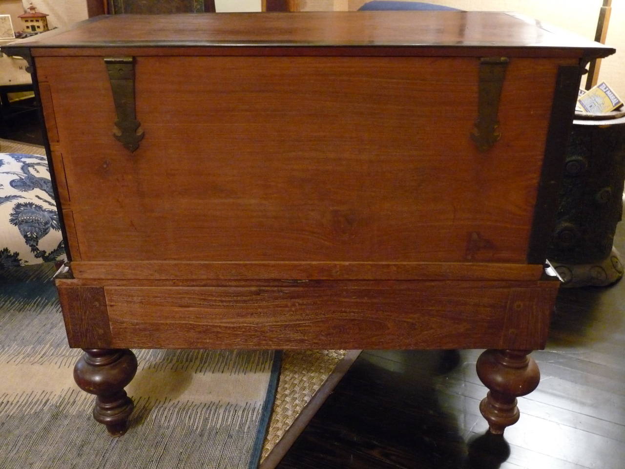 A great British colonial chest made of teak and ebony with solid brass trim. The top section offers ample storage and, sits on two drawers and has substantial turned legs.