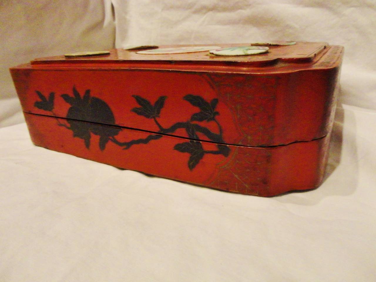 Beautiful box is painted in brilliant, pure cinnabar red, a prized lacquer that's till this day admired and treasured. Delicate ink paintings depict various flowers and butterflies which are symbols of happiness and love. Another important feature
