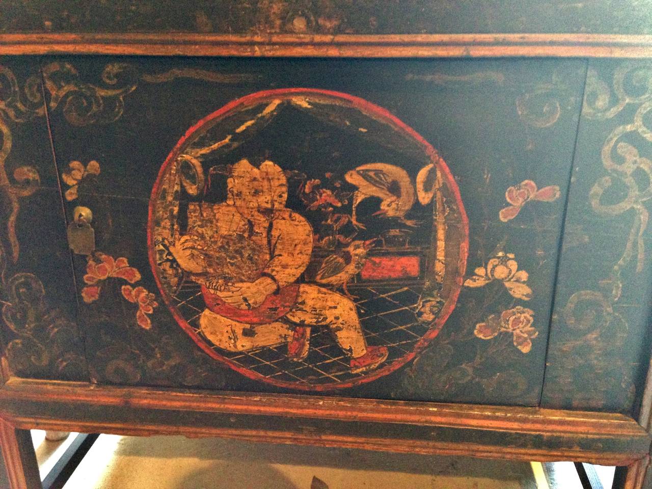 A wonderful piece from Northwestern China's exotic tribal region. Charming, folk artsy images of a chubby boy with birds surrounded by blooming lotuses form a happy, peaceful scene of life. Beautiful contrasting colors and patina. Removable shelf