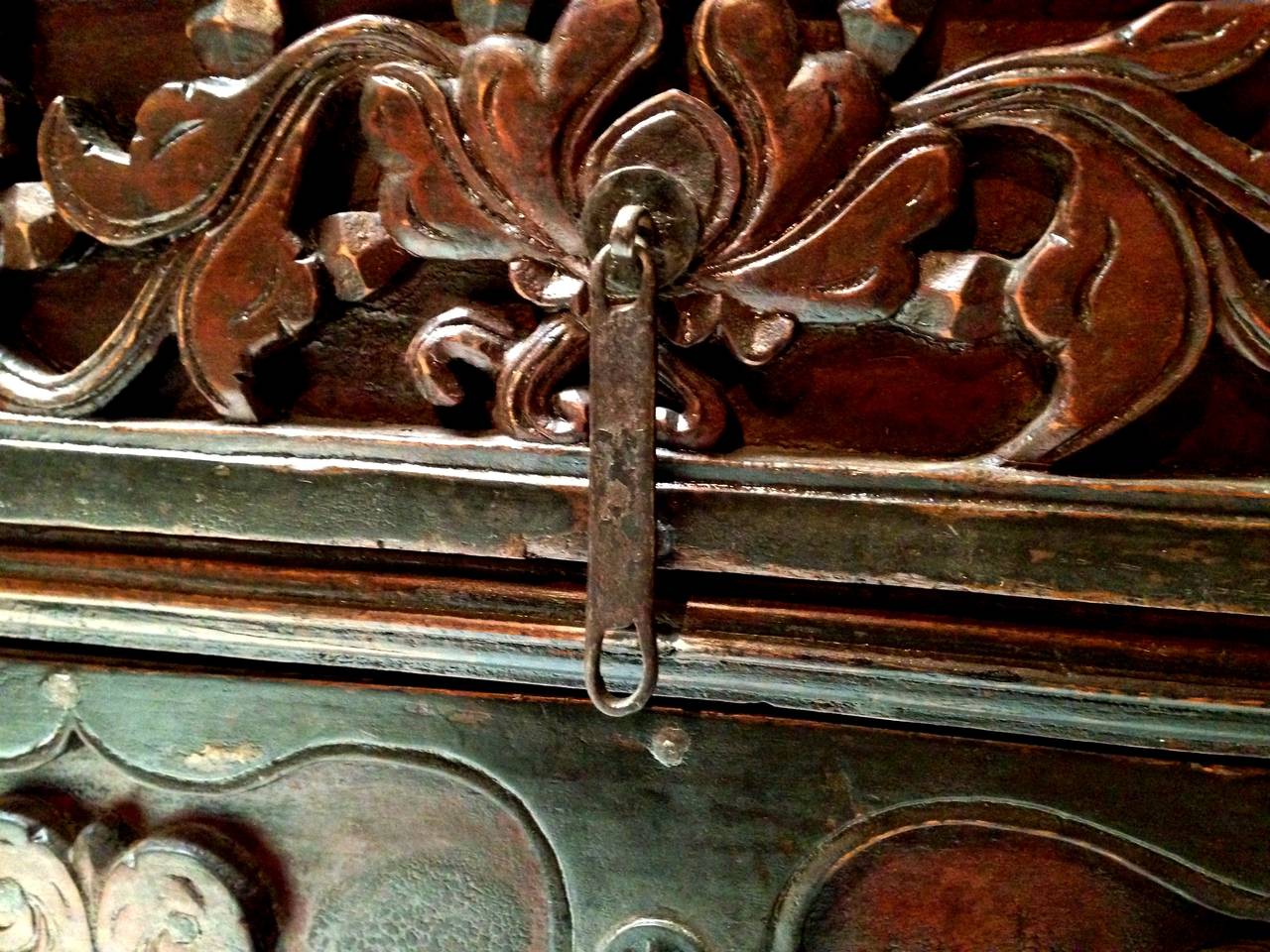 This wonderful piece demonstrates the rustic beauty of Northern China's furniture in the 19th century. Beautiful deep cut peonies are the focal points. Original iron pulls attached to ancient coins remain fully functional. Original iron studs can