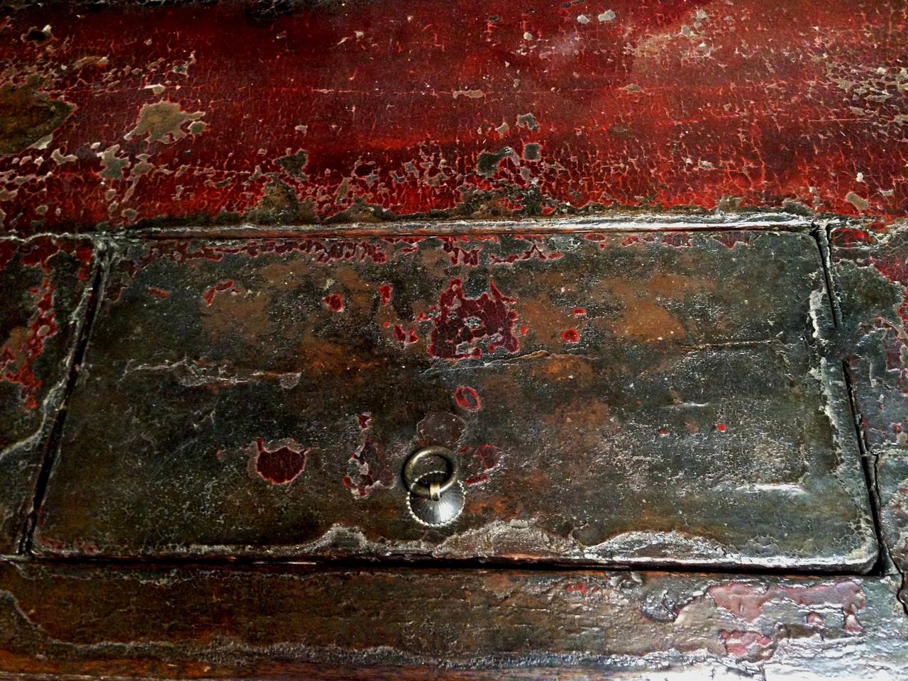 All original Mongolian chest is stunning with its extraordinary color of red. A center medallion featuring a gathered flower group symbolizing unity is of typical Mongolian style. The top has an original opening that reveals deep interior capacity