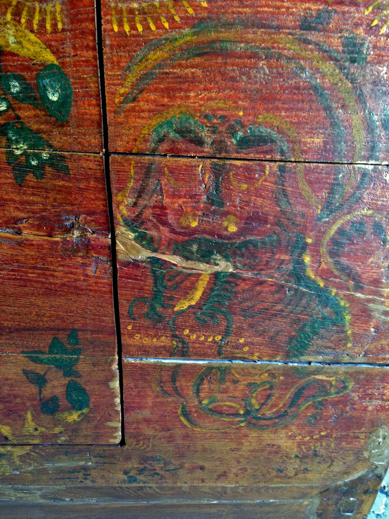 This wonderful piece exemplifies the rustic beauty of silk route region's furniture. Only solid single boards of wood were chosen for its construction. Exotic, folk artsy images are often found on furniture from that region. Here a pair of playful