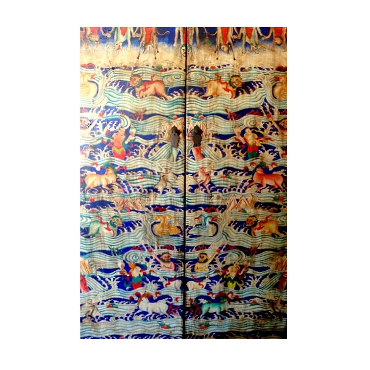 This magnificent cabinet is completely hand painted. Its depiction demonstrates the Tibetan theory of reincarnation. Myriads of saturated colors were employed to express fantastic artistry, colors such as burned orange, butterscotch saffron, and