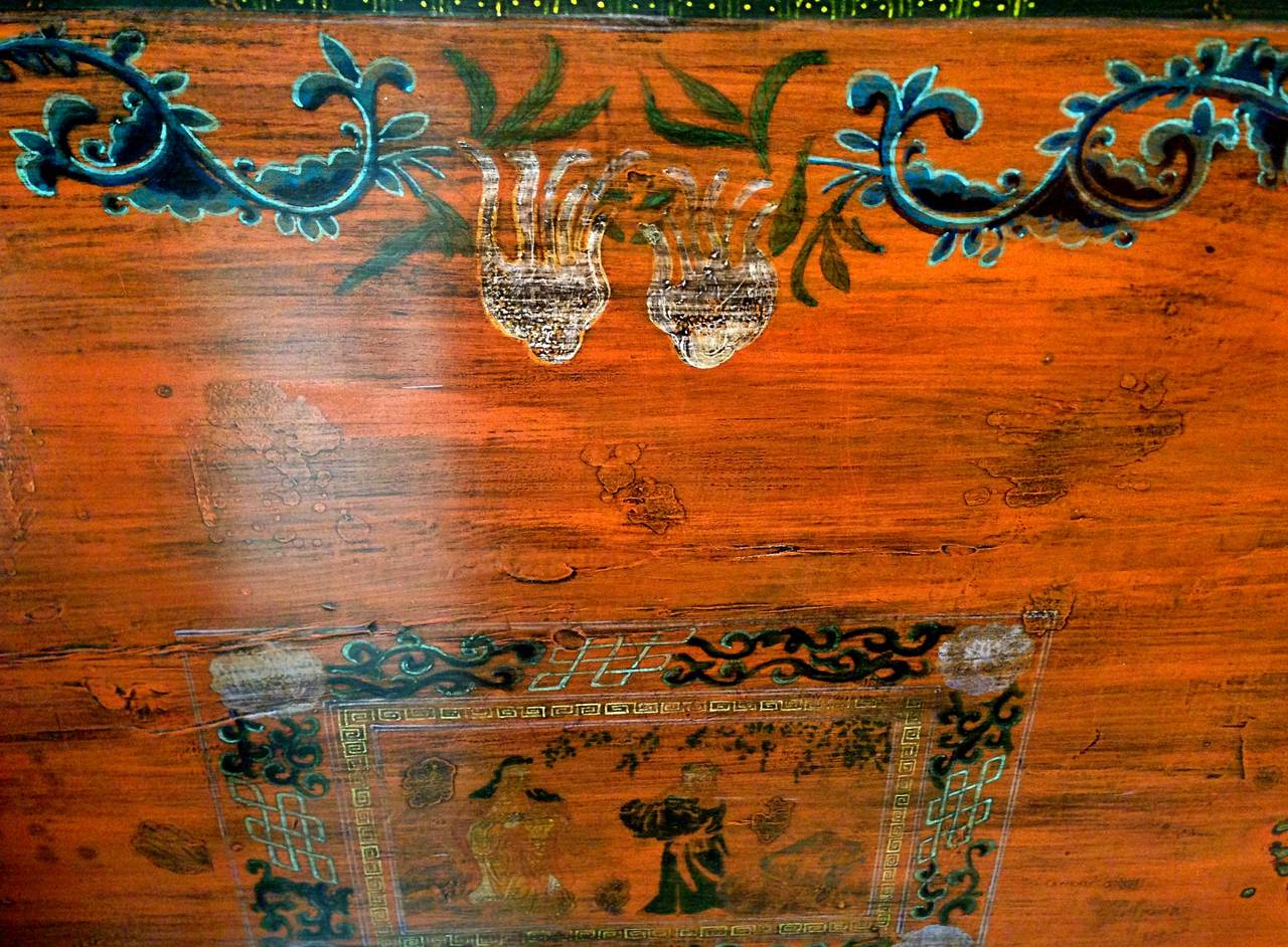 This Mongolian chest is painted in a lustrous dark green lacquer with a glorious saffron contrast. Its center features Genghis Khan in a friendly exchange with a fellow tribe leader. The hand painted depiction is decorated with traditional Mongolian