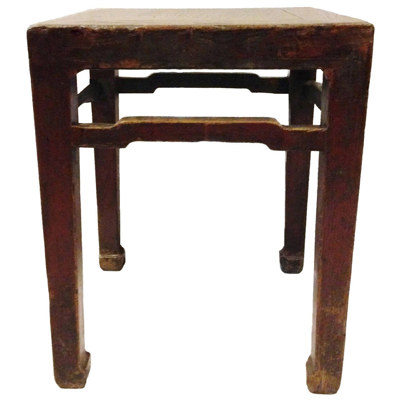 This beautiful stool was designed in the classic Ming style. Featuring hoof legs and raised stretchers, it is at once rustic and elegant. Original red lacquer remains partially visible. Versatile as stool or table. 

Solid wood. Tenons and