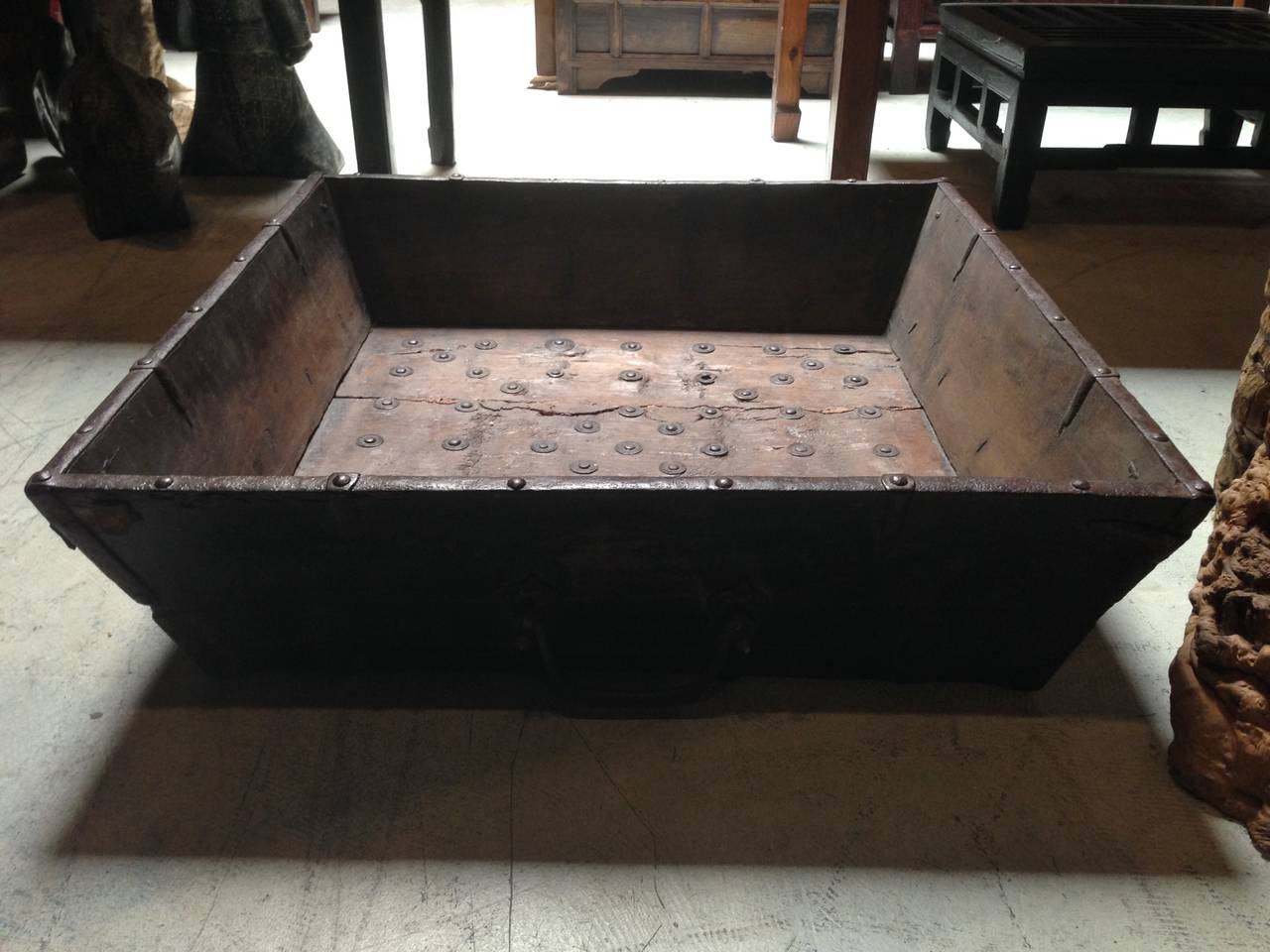This fantastic wooden trough is truly substantial. Solid wood is decorated with beautiful iron studs. What makes the trough special and very valuable is that these studs are mounted on antique coins. Iron brackets and iron handles further strengthen