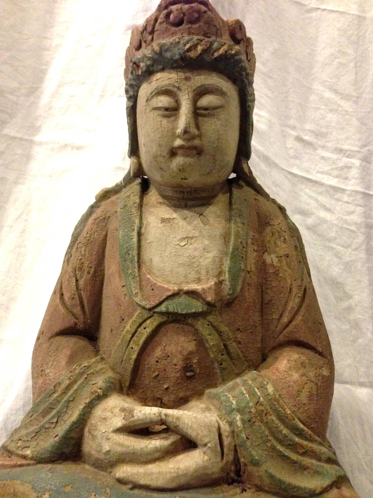 Beautiful Guan Yin has the dhyana mudra which expresses absolute balance and complete harmony. Soft pastels are unique and soothing to the eyes. Aged crackle is part of its amazing patina. Hand carved of wood. Guan Yin is the most beloved Goddess of