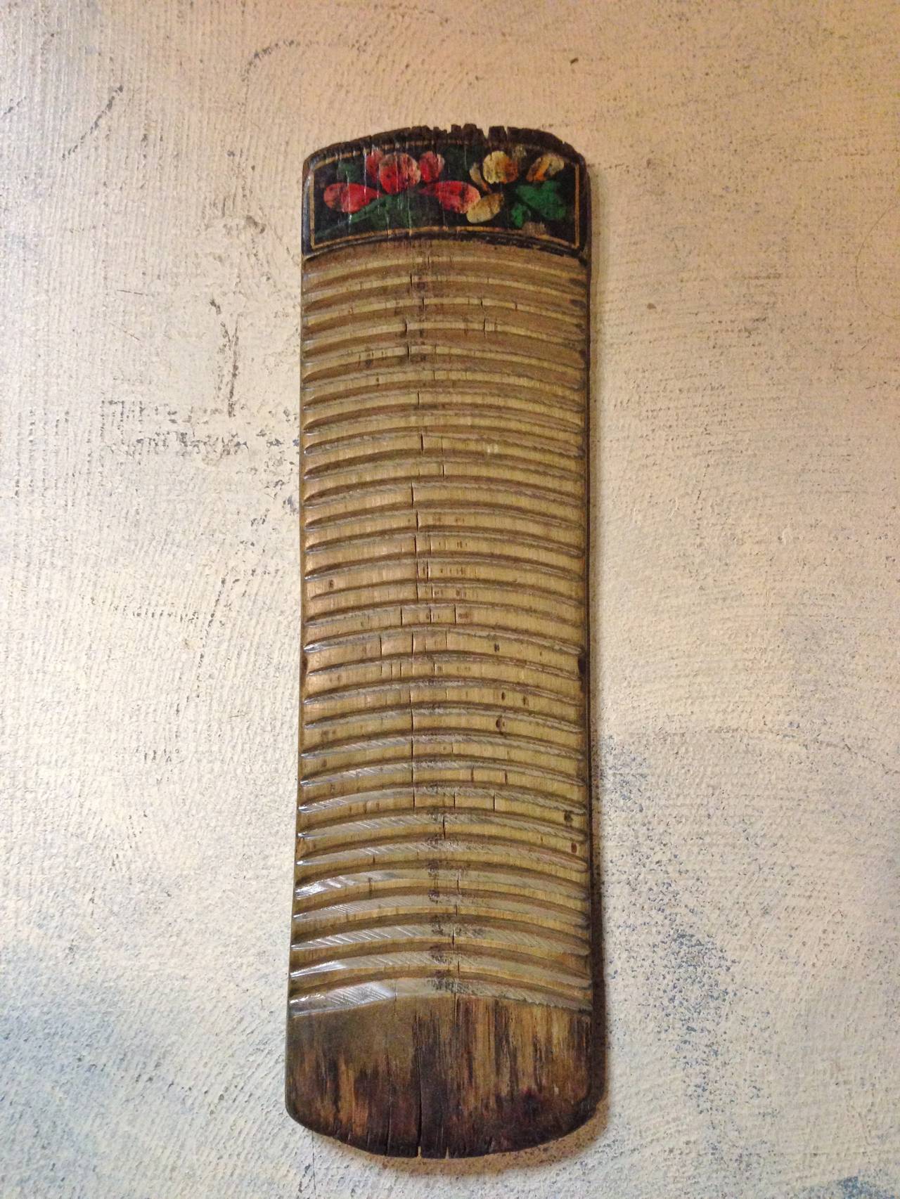 Our antique washboards are beautiful with their rustic, aged patina. Made of solid wood, they feature pretty painted flowers at one end. Each piece has its own unique degree of wear. Back in 19th century when doing laundry by the riverside is a