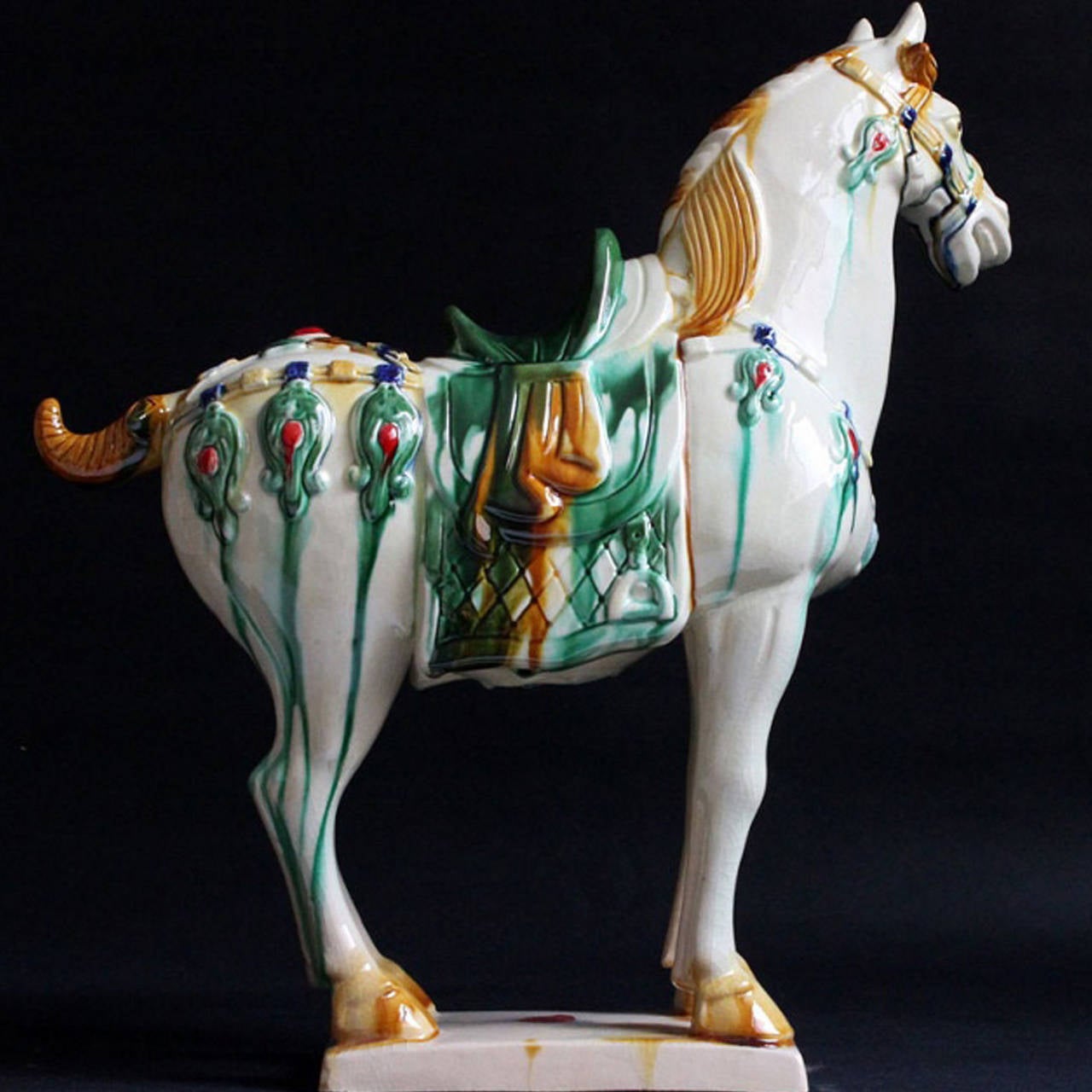 Beautiful terracotta horse is hand made and painted using the ancient Tri-Glaze techniques. A true work of art, the splendid glossy glaze is distinctive of Tang San Cai style. Glaze is skillfully applied achieving high artistic effect. Horse's vivid