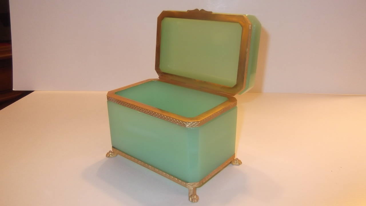 Rare soft apple green opaline glass table box.
Smooth sides and notched corners with nice leaf pattern gilt 
ormolu mounts all resting on paw feet.
All gilt is in excellent condition