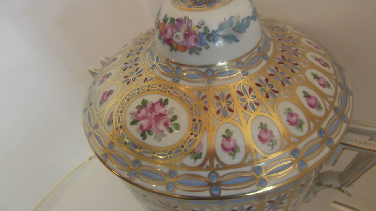 A Large hand painted Dresden urn
Generous size with detailed hand painted floral decoration all over.  Lost of gilt highlights and unusual double handles
Clearly marked 