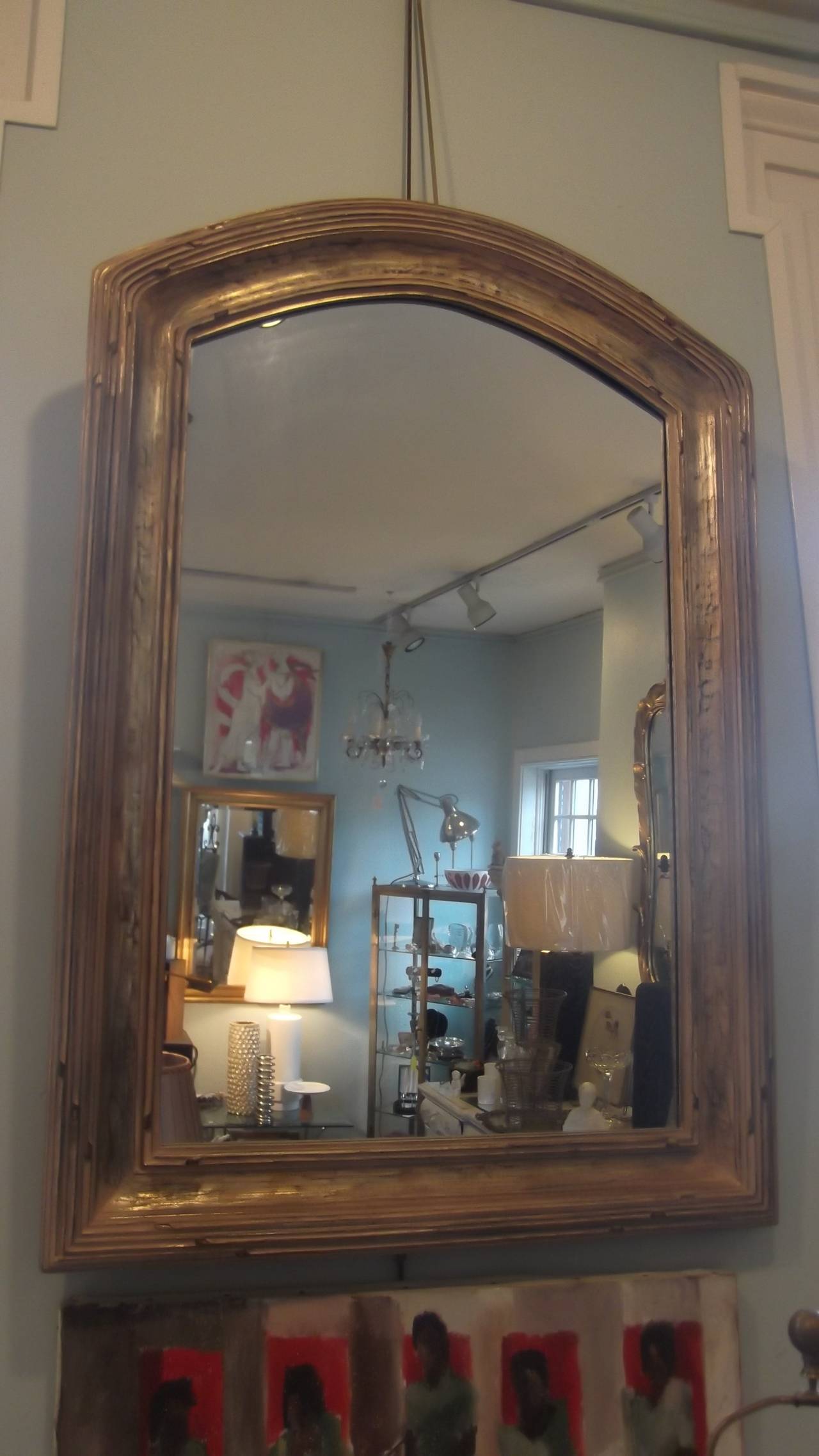 Pair of 20th century decorative carved gilt wood mirrors with arched tops.
Nice concave molding with slight distressed gilding.  Nice substantial depth to the frame.