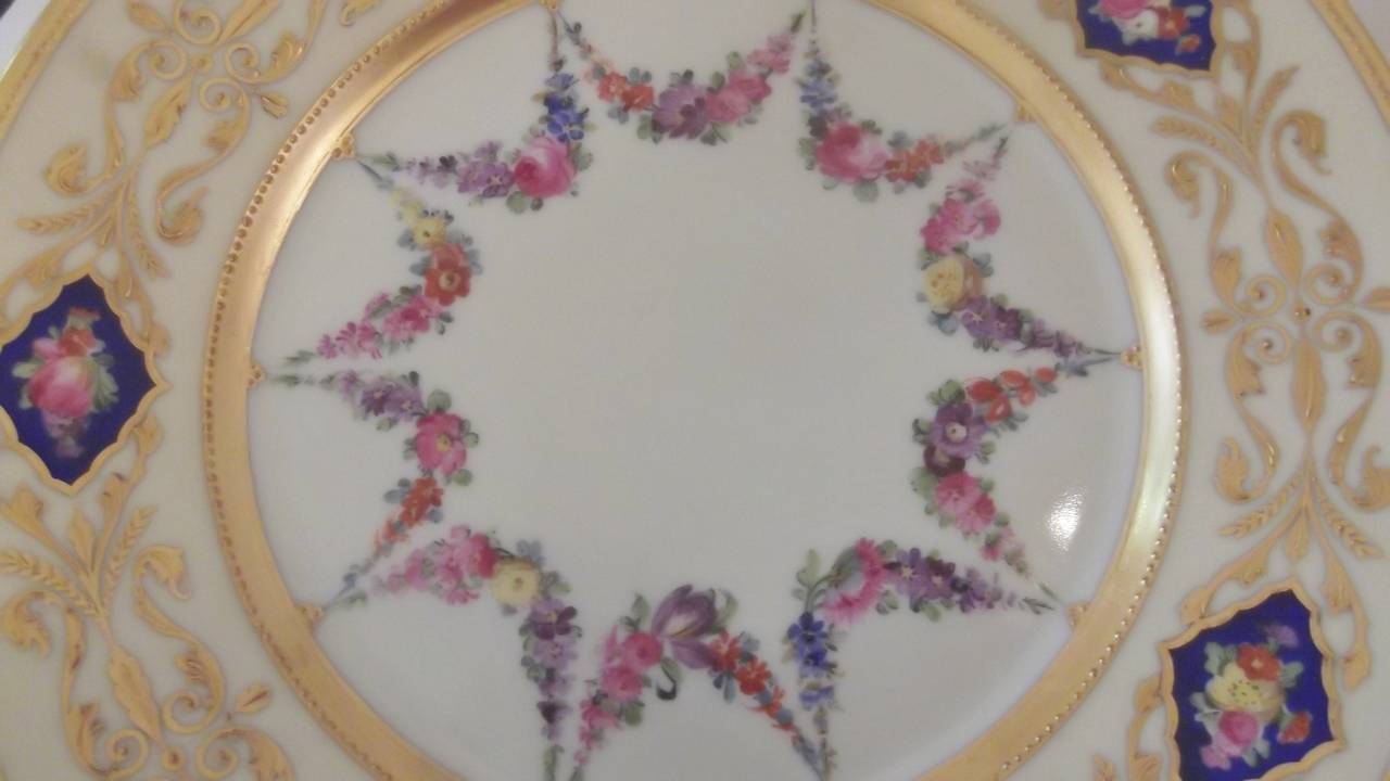 German A set of 12 Hand Painted Accent Plates with raised gilding.