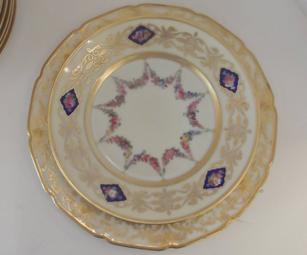 Porcelain A set of 12 Hand Painted Accent Plates with raised gilding.