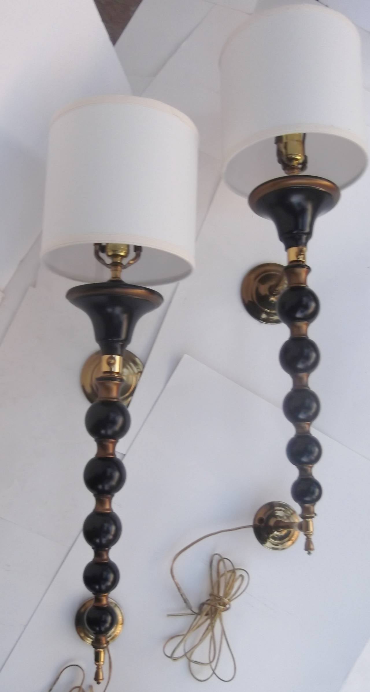 A Pair of Mid Century Torch Sconces