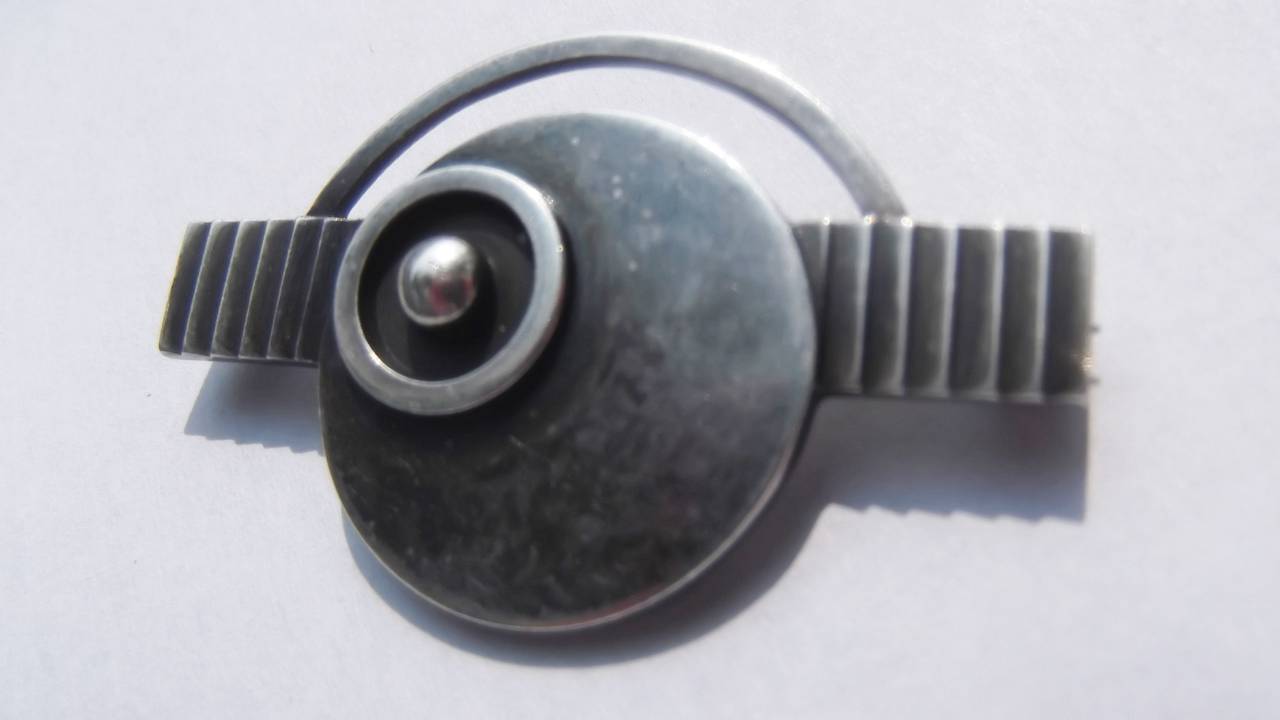 Offered is a rare brooch in sterling silver by Georg Jensen. It is not large, measuring 1" x 1.5". The brooch was designed by architect Oscar Gundlach-Pedersen during his time as manager of Georg Jensen silversmiths. Gundlach-Pedersen