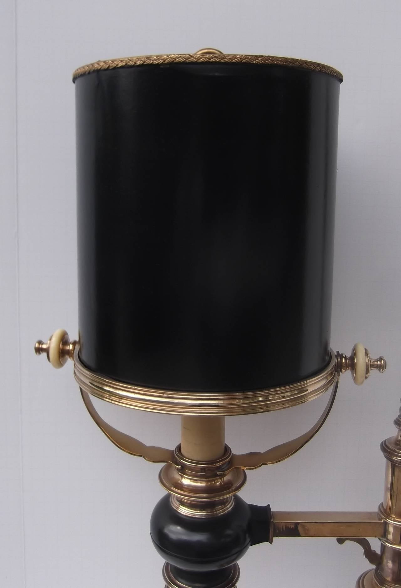 A cast brass and black enameled Chapman desk lamp.
Unusual drum parchment shade (original) fits into the brass ring shade holder with classic Chapman off-white knobs. The tall pole on one side gives this lamp a handsome balance, the square pedestal