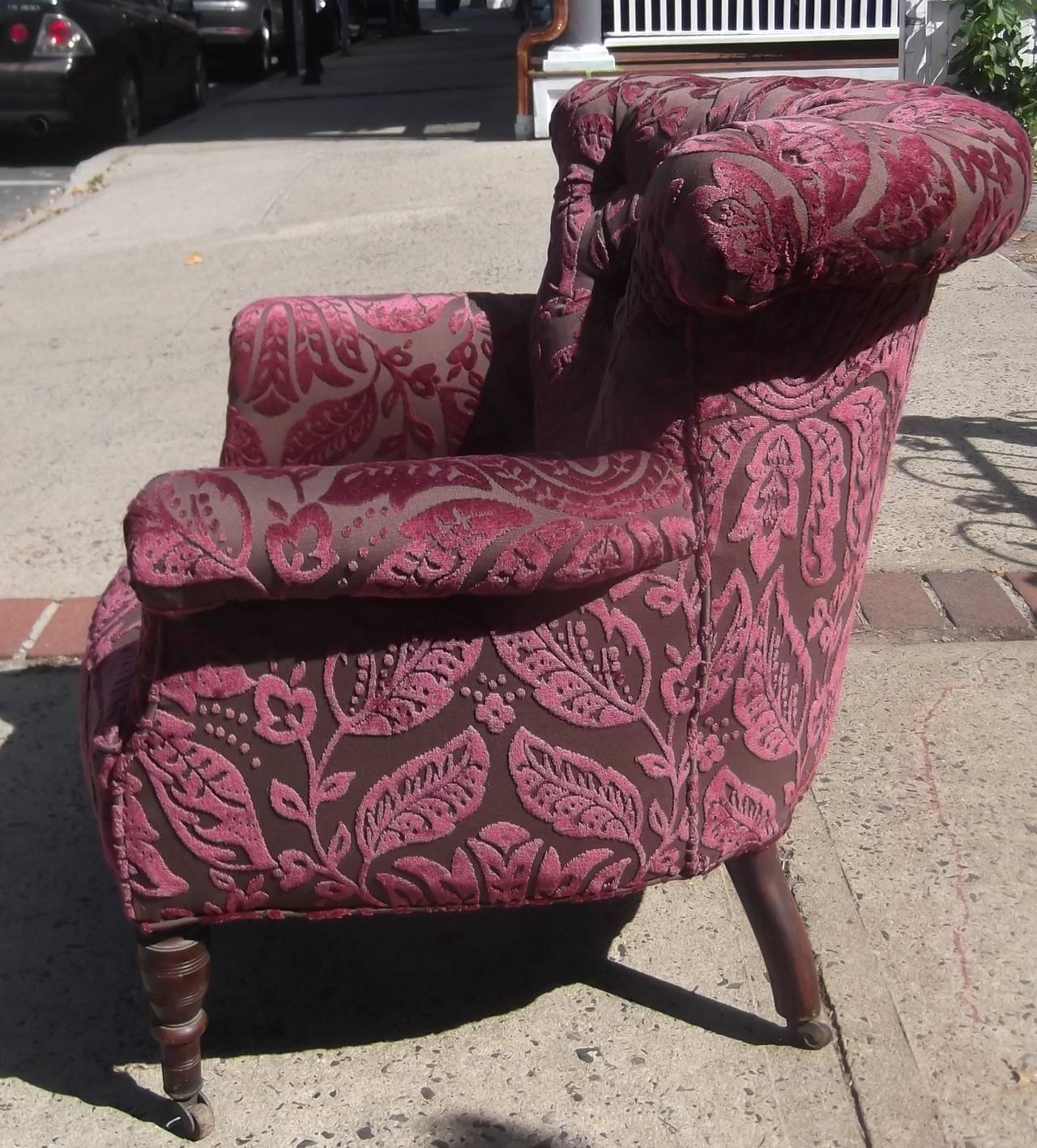Very shapely tufted armchair with new upholstery.
Comfortable curved back with rolled over detail. Eight-way hand tied springs with turned walnut legs. This is a diminutive size and can be tucked away easily.
The fabric is a berry velvet with a